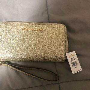 Michael Kors wallet. Your phone could fit in it!